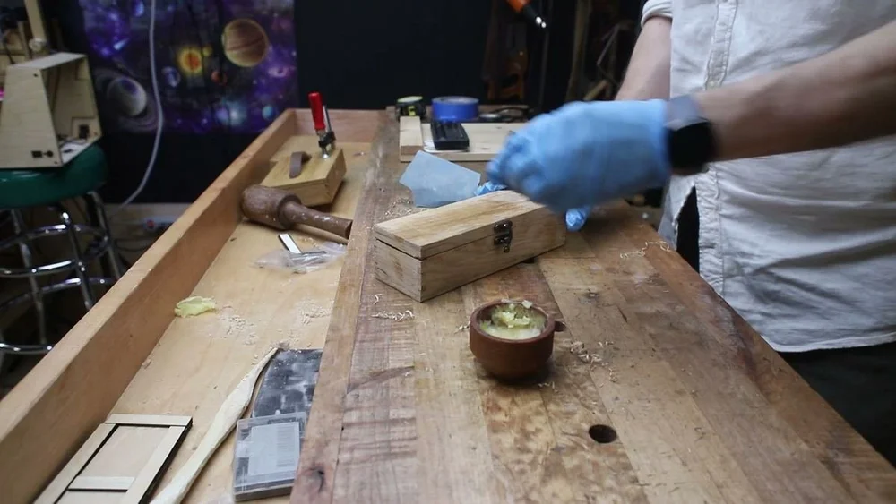 Sanding wax polish into the oak