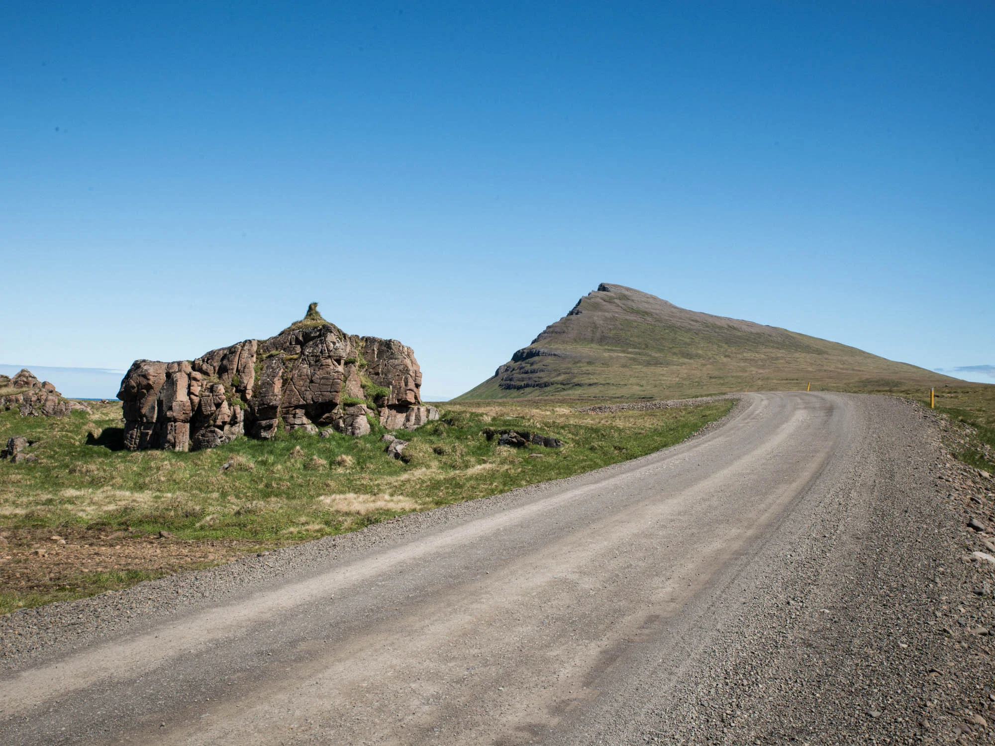 Project published in book form by “Bjartur Veröld” in Iceland November 2018. In Iceland, the folklore around Elves is still affecting some aspects of modern life. Although most Icelanders would not openly admit to believing in the creatures, opinion polls indicate that people usually choose to "neither affirm nor deny” their existence. Icelandic elves, also known as hidden people, are not like the English term connotes. They are said to be usually invisible people, a bit different from humans who live alongside us, mostly in rocks and boulders or bigger stones in lava fields. Many legends exist about humans interfering with elves homes and how they get punished for it – someone is taken ill or machines break down in most mysterious ways. Therefore, when roadwork and housing construction become problematic, it is often seen as a warning or retaliation against on-going construction on the "elfin property". Due to this, some construction managers would rather comply with the perceived wishes of the hidden beings than take any chances on further accidents happening. This might involve giving the elves time to relocate or abandon their homes or even change the construction plans altogether to accommodate them. The Crossroads project seeks to document the locations where the belief in elves has changed the face of modern living. It tells the stories behind elfin monuments that remain in the urban landscape, many of which only existed as verbal legends. The project is not only intended to serve as an important documentation and visual evidence of the elfin folklore in Iceland, but also as a reminder of the many manifestations of nature in modern society. Concepts of the supernatural reflect the culture to which they belong. The folklore around elves represent nature in the culture - and even nature in the city. The elves can be seen as nature spirits and they are a part of nature and by protecting and respecting nature - humans respect the elves. Their homes – rocks, hills, cliffs - must not be tampered with. Narratives about insurrection of elves demonstrate supernatural sanction against development and even urbanization. They protect and enforce the old pastoral values and traditional rural culture. The clashes that are narrated in these stories or legends refer to oppositions that were relevant in their social and ideological settings in pre-industrial and rural society. Roads and construction in lava fields or “unspoiled” nature are the matrix of modernity. Road construction transgresses these boundaries and cross between nature and human settlements (the city), and bring the nature into the human’s domain. Elves are usually described as beautiful beings, similar to humans but very sustainable in their way of living, a bit like Icelanders from two or three centuries back. This nostalgic idea of a nature-oriented elfin society existing today reflects how we see our own modern lifestyle today and even expresses doubts about how unsustainable we have become. This folklore is therefore, never only about elves or the "others", but about humans or "us" and how we choose to live in a community, with and beside nature.