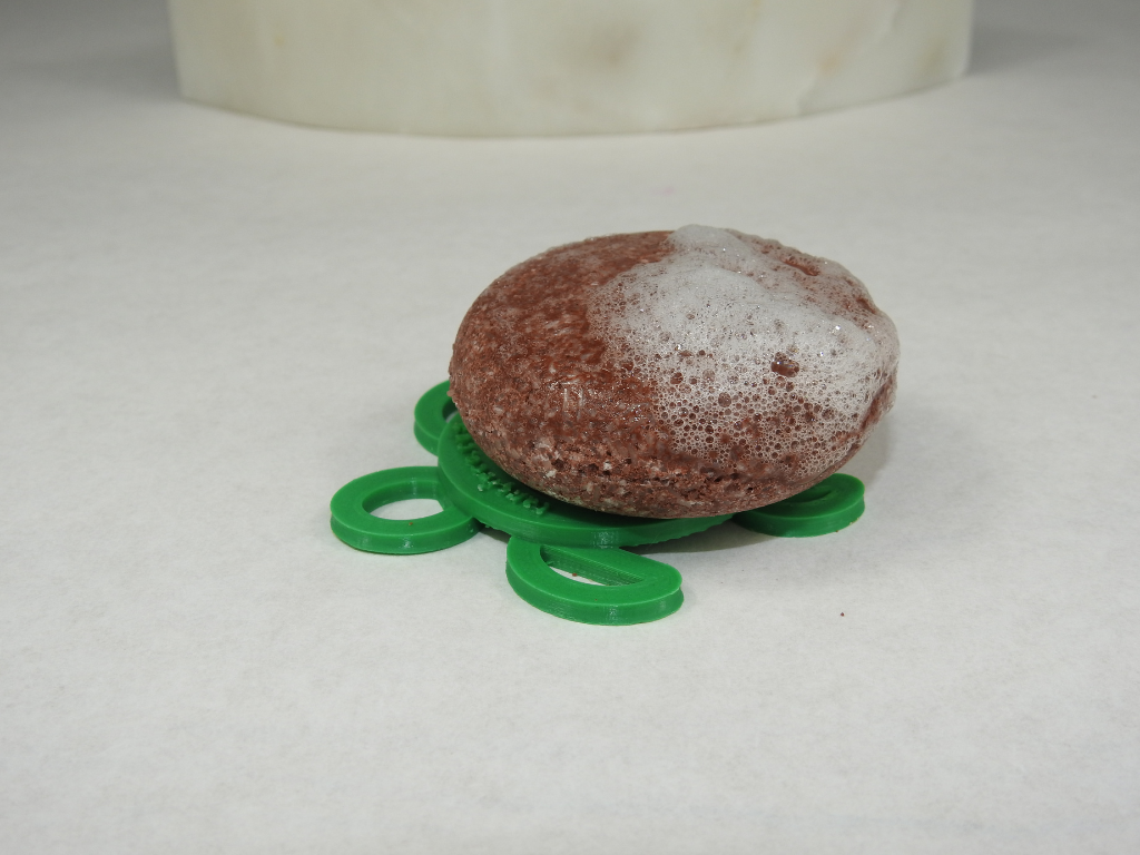 Tangie Superfoods shampoo bar with bubbles on turtle drying disk.png