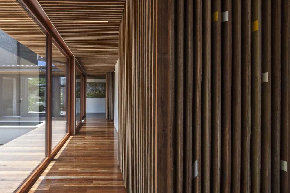 Spotted Gum flooring salvaged from a basketball stadium used as wall cladding with the line markings remaining as a feature