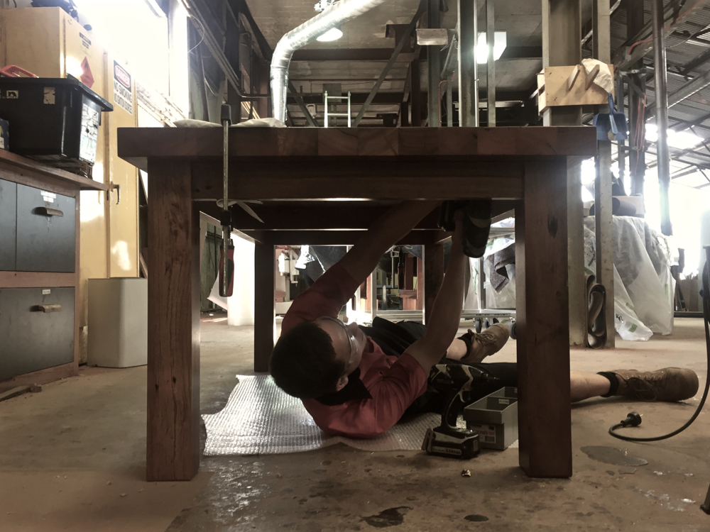Liam Kruttschnitt fixing the table top to the base, it's off to it’s new home and first Christmas dinner! Extra thick recycled Blackbutt table top made out of salvaged 100x75mm floor bearers. This one is heavy!