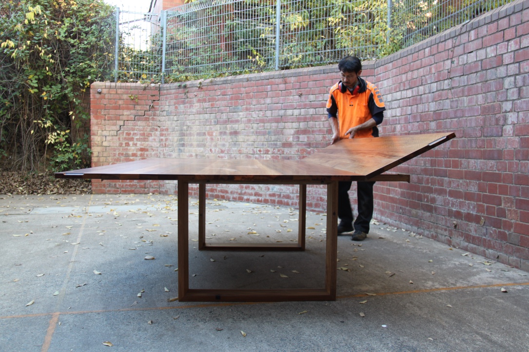 Folding leaf table built in recycled Spotted Gum. Seats 8 when closed or 14 when at full extension.