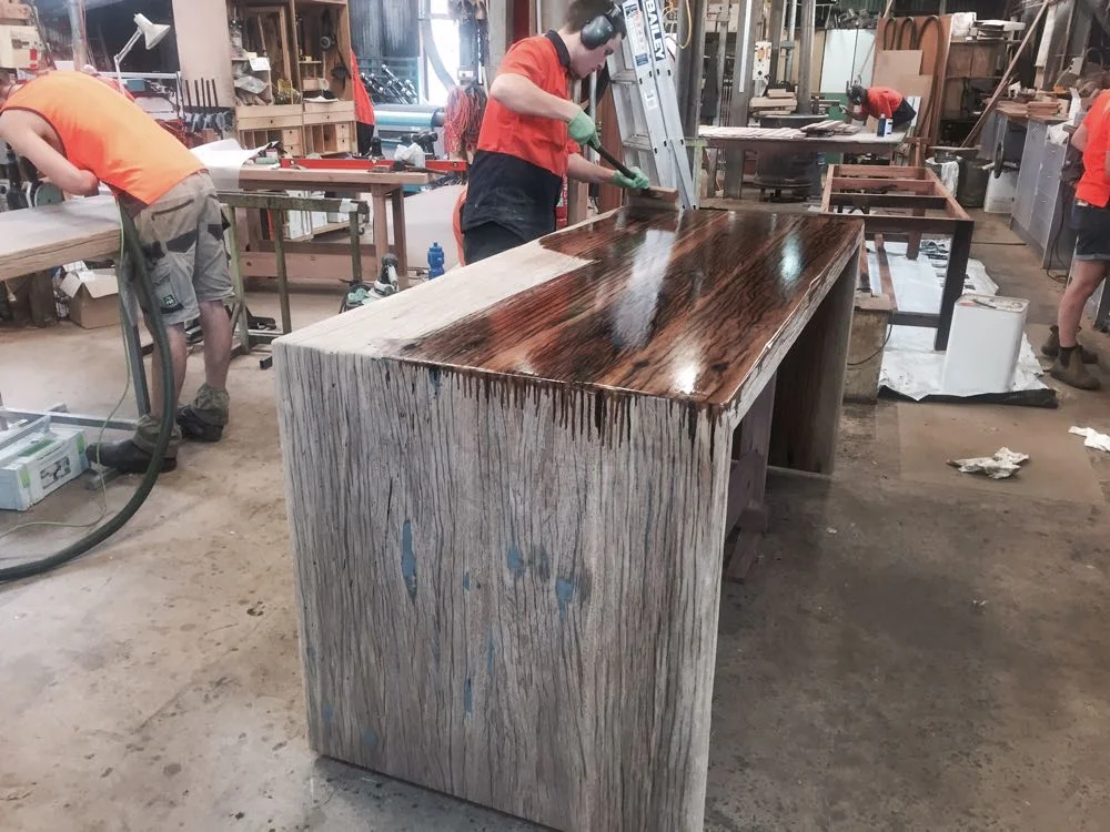 The Kitchen waterfall island bench being finished in Osmo Hard Wax Oil. Osmo is made from plant oils and waxes and is food safe. It brings out the colour and grain of the timber with a very natural appearance.
