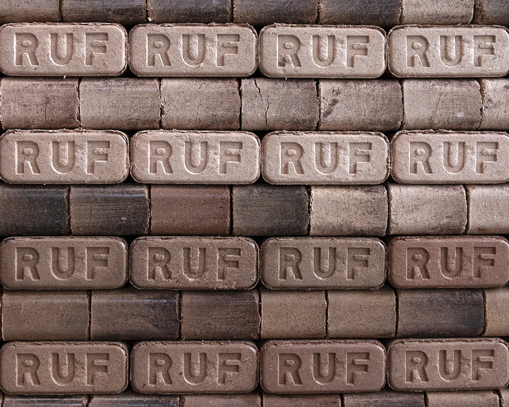 Fire briquettes neatly stacked on a pallet.