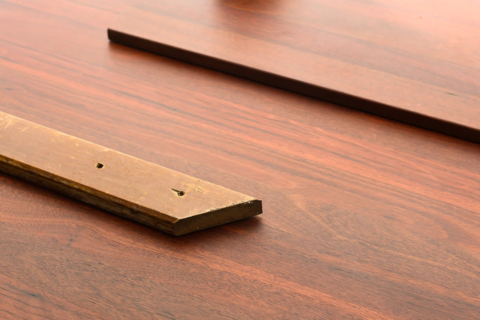 Some of the original, unfinished pieces of Jarrah contrasted with the finished benchtop.