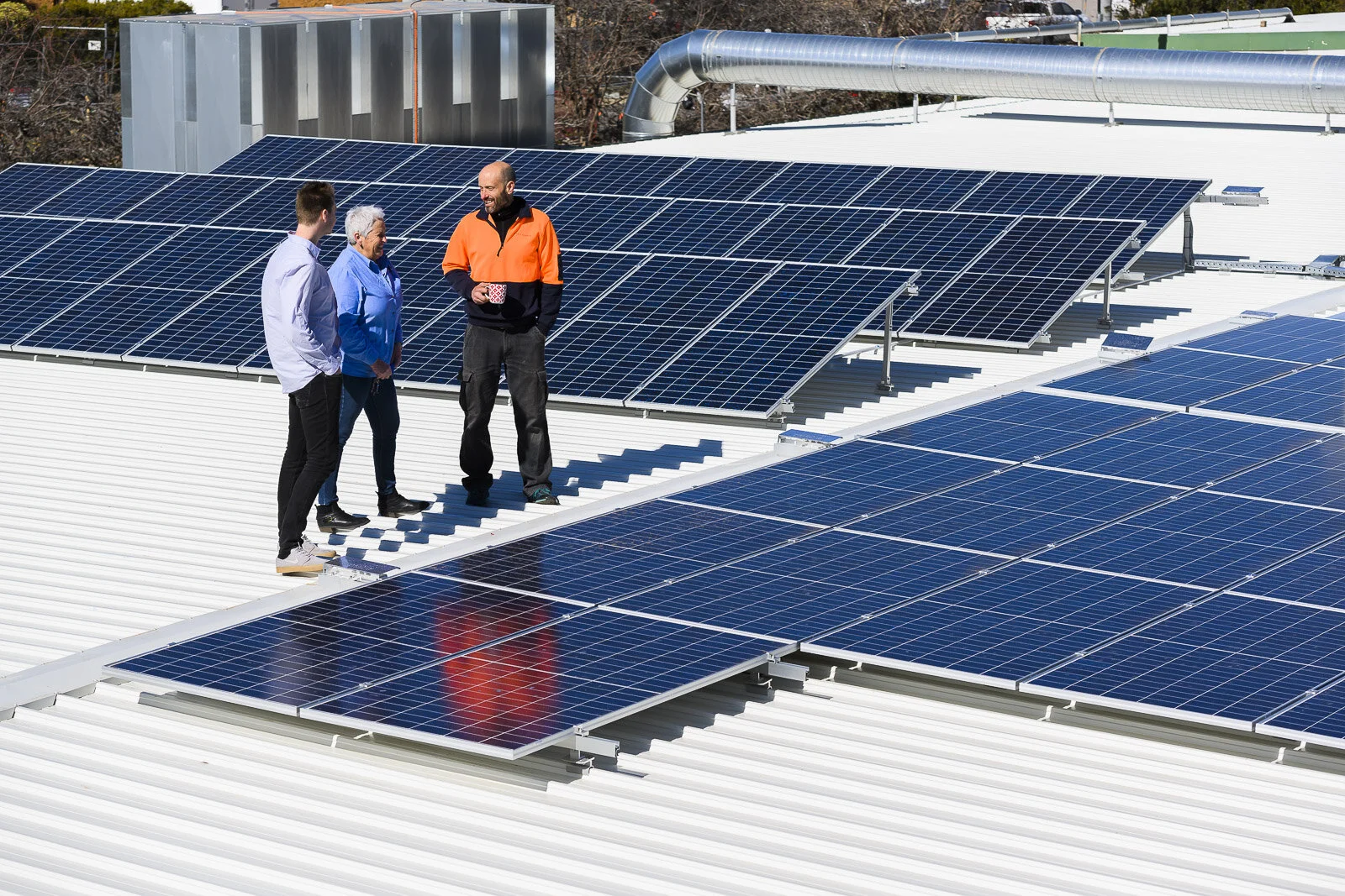 Thor having a cuppa with the Solar4Life team next to our 90 new high-efficiency Canadian panels.