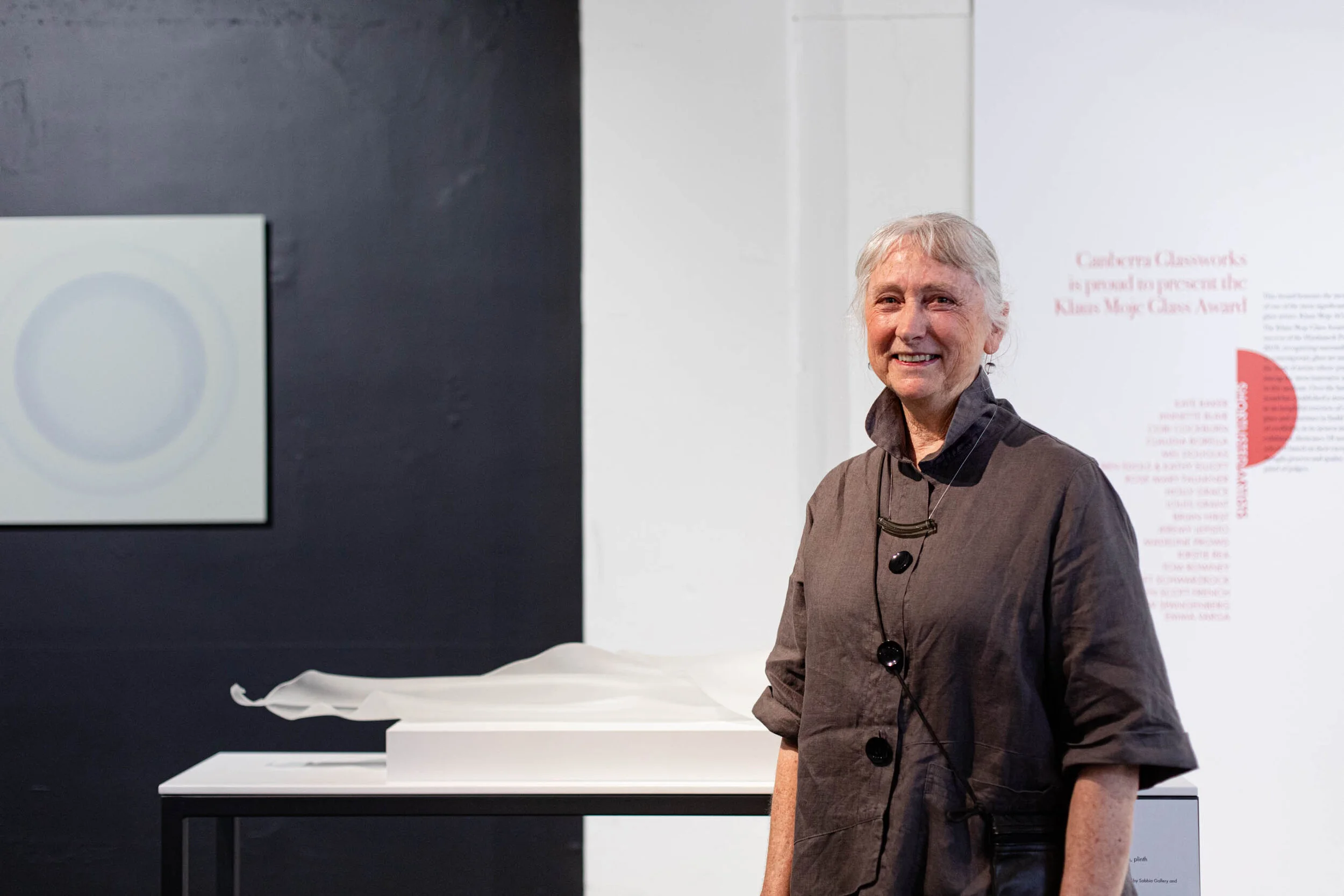 Kirstie with her work - ‘What remains’ kiln formed glass. Photo: David Paterson