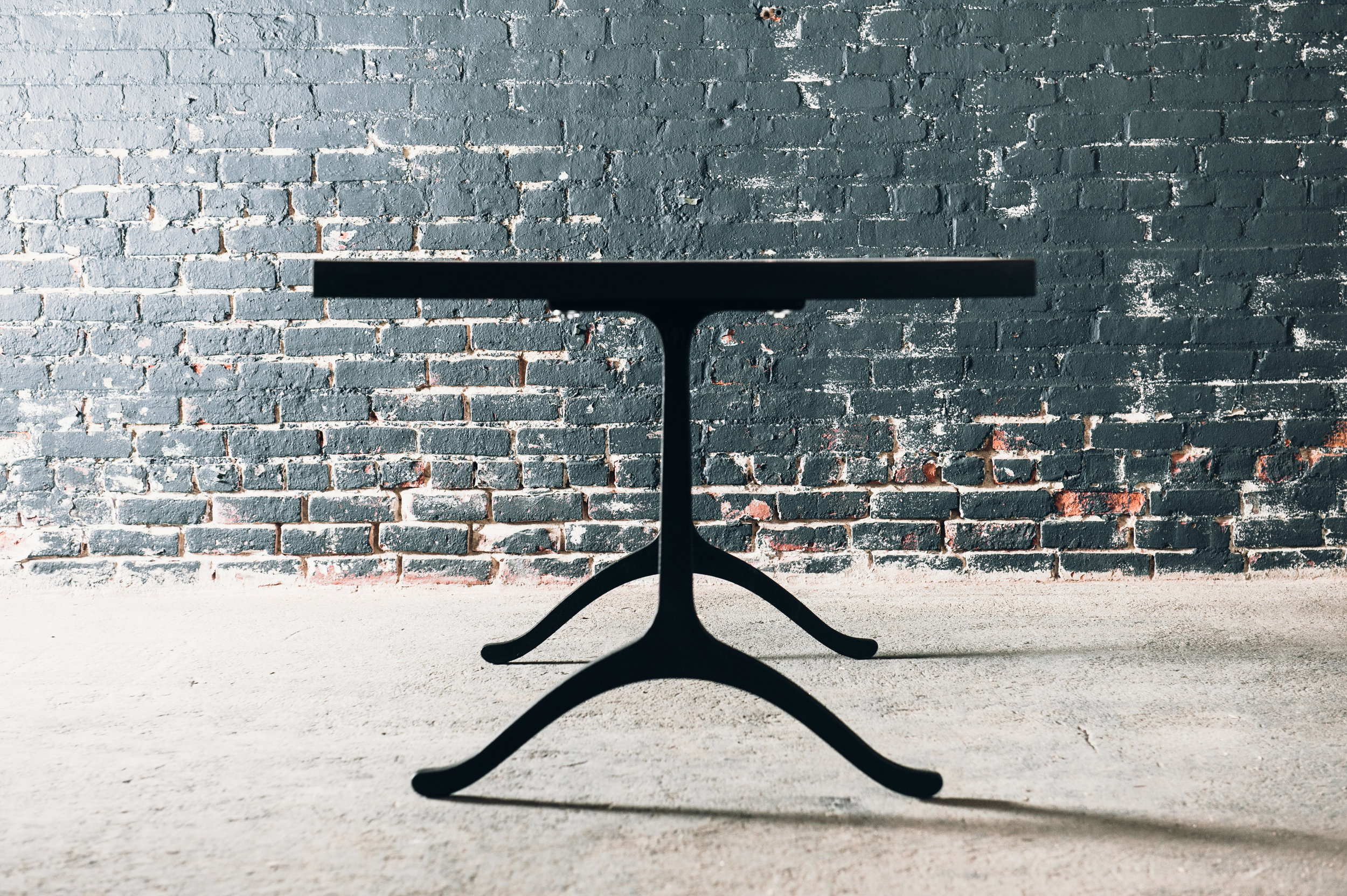 Slab table with cast iron base