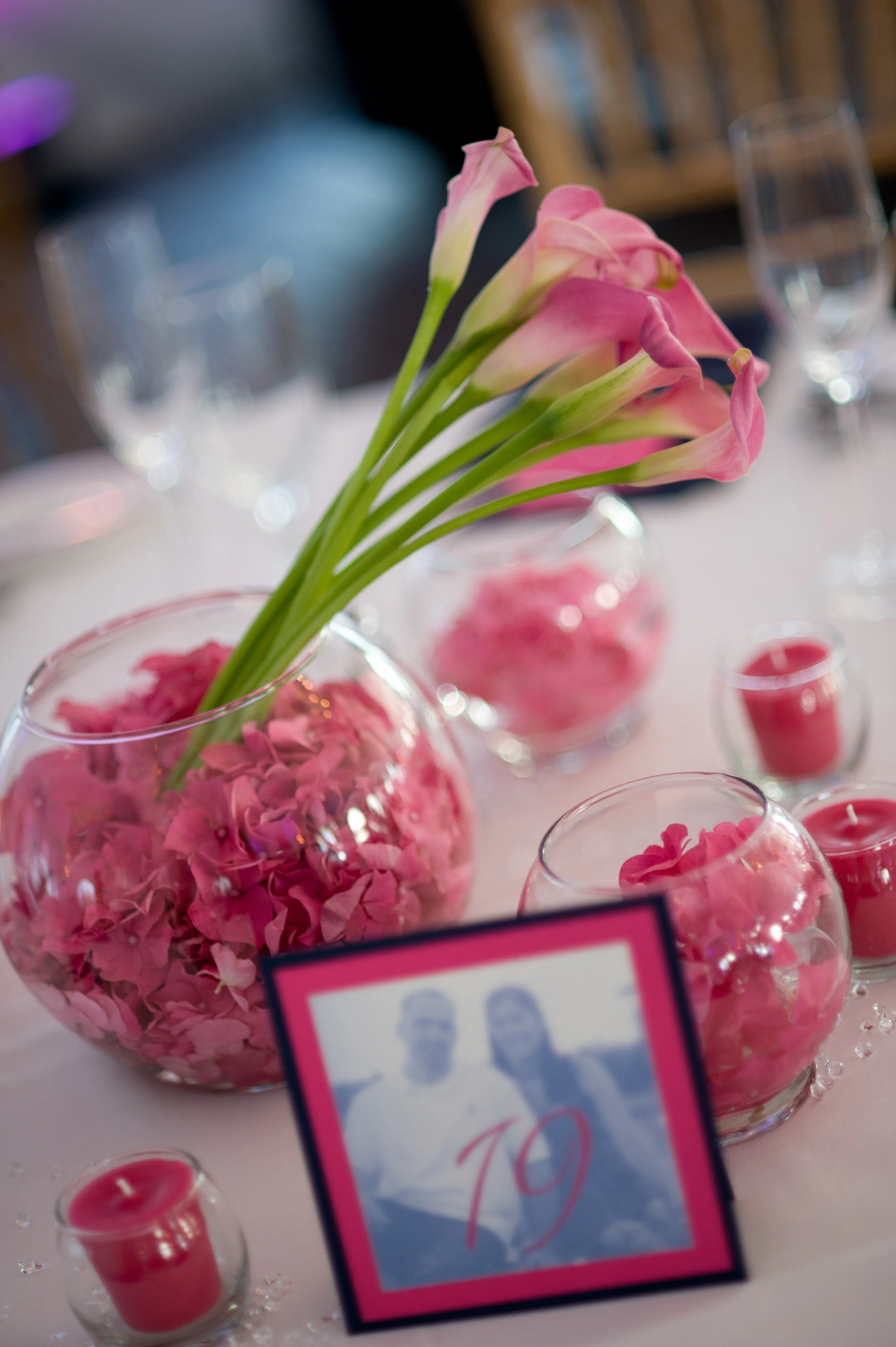 We loved the low pink centerpieces and our signature square photo table numbers!