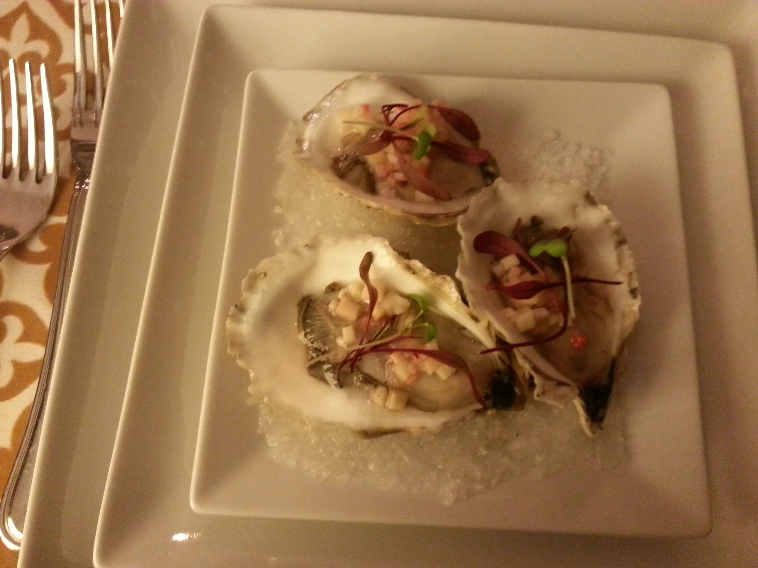Oysters on the half shell with quick pickle, bull's blood shoots