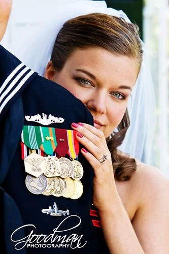 This is a great photo of a proud bride and her Navy sailor groom!