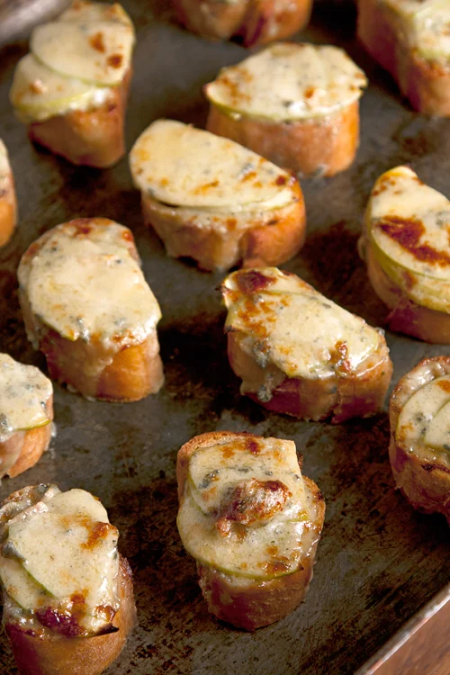 When I was younger I thought the dish was called "Welsh Rabbit and included rabbit. (eek!) But then I realized it was Welsh RAREBIT which is basically a cheese sauce poured over pieces of bread and them broiled. I am still trying to make up for not eating Welsh Rarebit all those years. This version contains apple and Stilton cheese - a delicious English Bleu cheese.