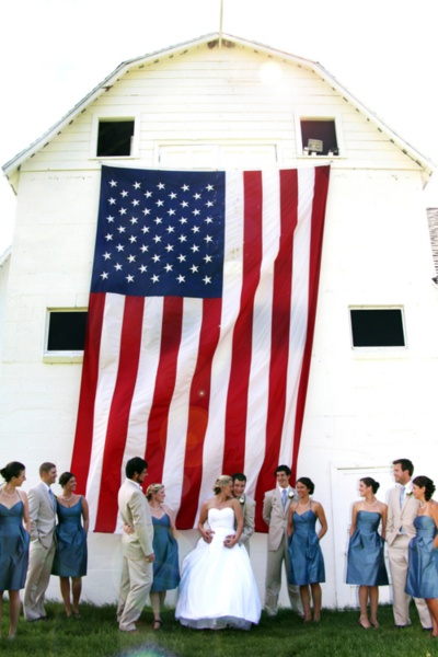Such a great impromptu picture of the bride, groom and bridal party with the perfect flag backdrop. Happy Birthday America!
