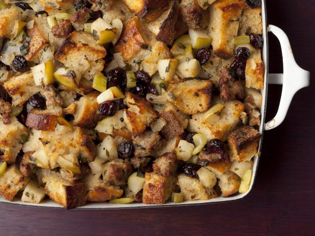 Ina Garten's Barefoot Contessa recipe for Sausage and Herb Stuffing - I love a good stuffing. Sometimes we love it more than the Turkey! (sh!). Ina Garten's recipes always work out so well because she painstakingly tests and re-tests her recipes. It's no wonder why her cookbooks in my collection are lovingly spattered and stained from all the times we've used them. This Stuffing recipe is killer delicious. We promise!!