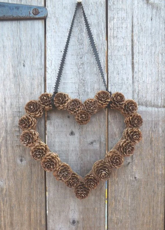 DIY Pine Cone Heart - Pine Cones are a great material for wreaths. We love this heart wreath for a wedding!