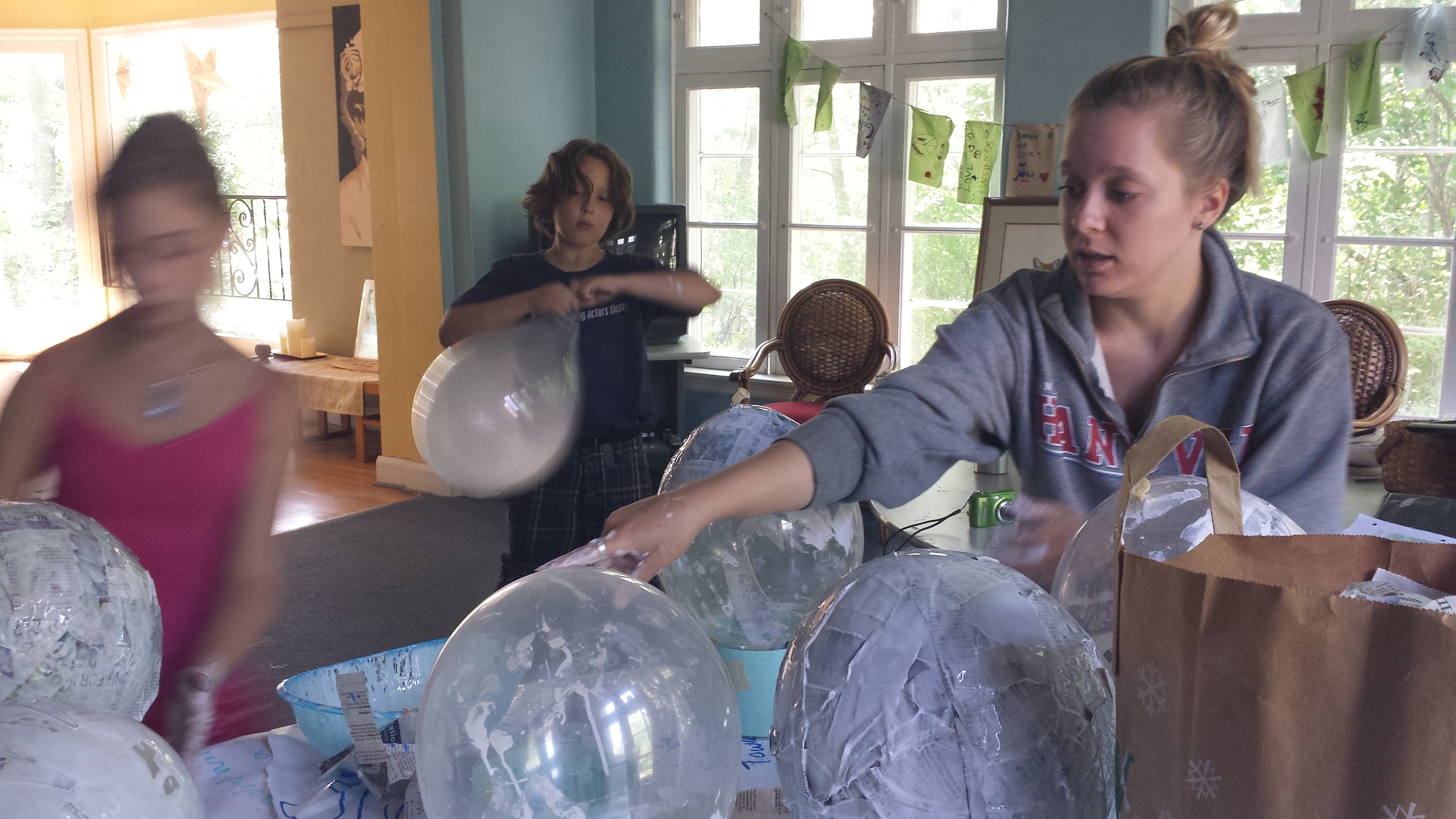 Author Alexis Litz, left, works with campers on a project that involved visualizing CO2: one pound of CO2 = the equivalent of 28 balloons.