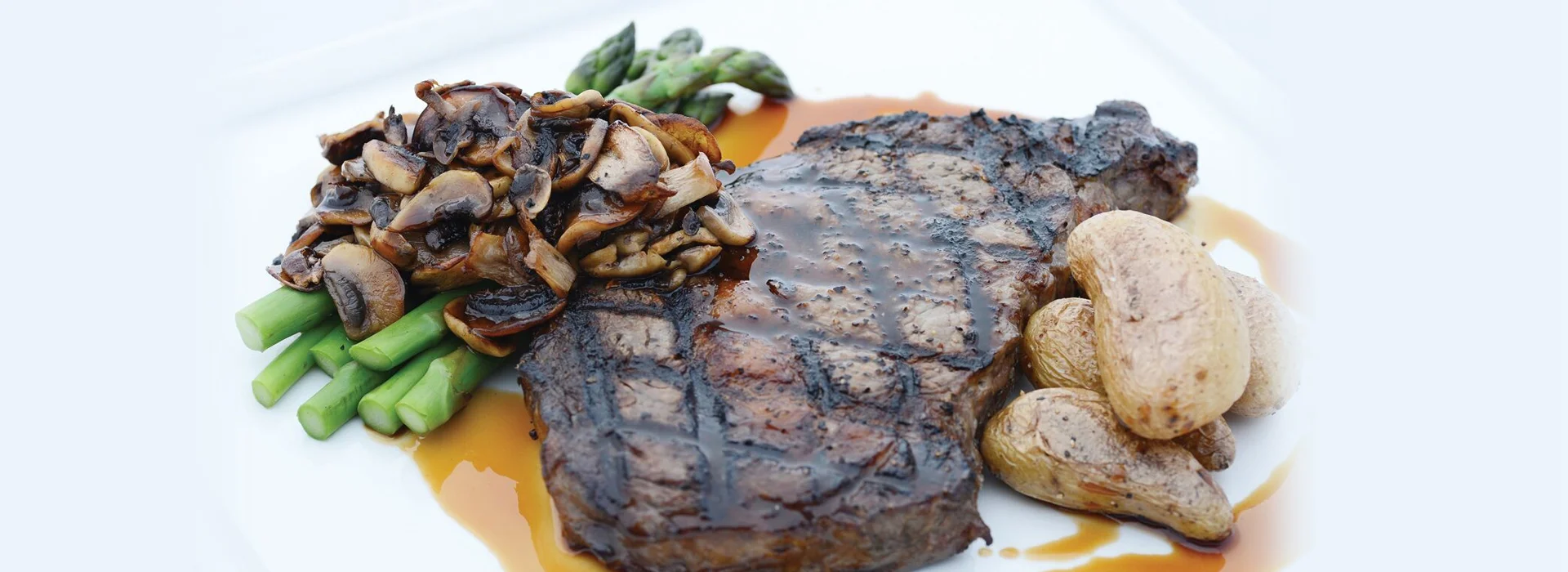 Locally Sourced Grilled Ribeye Steak with Sautéed Mushrooms