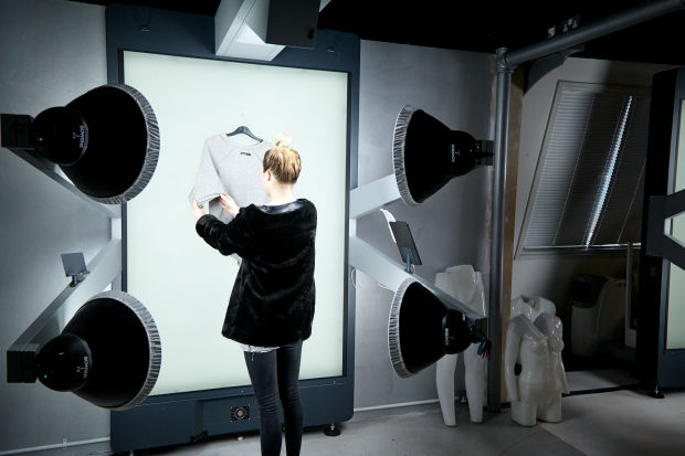 A stylist using one of Boohoo's several StyleShoots Vertical machines in their Manchester, UK HQ