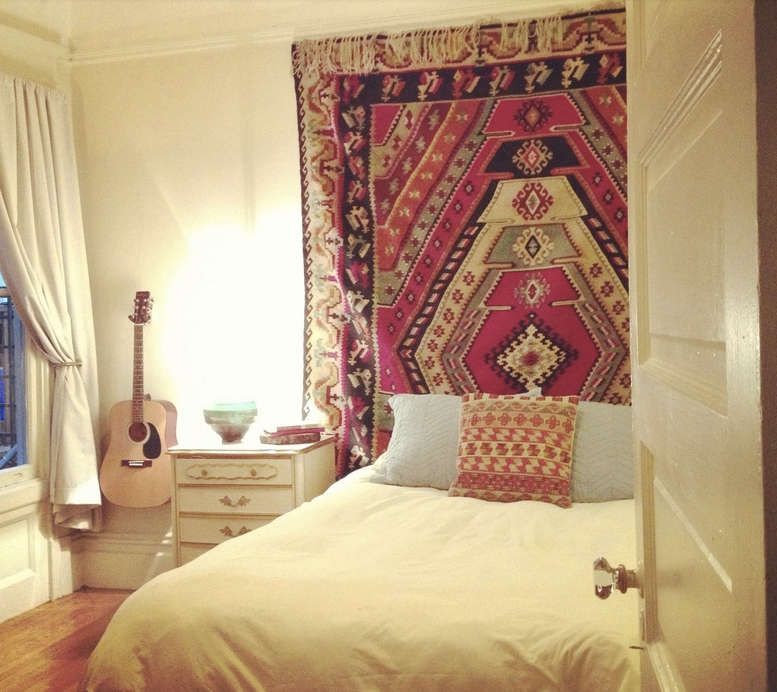After: A gorgeous rug previous rolled up and collecting dust under the bed serves as a gorgeous focal point, tying together the style of the entire space.