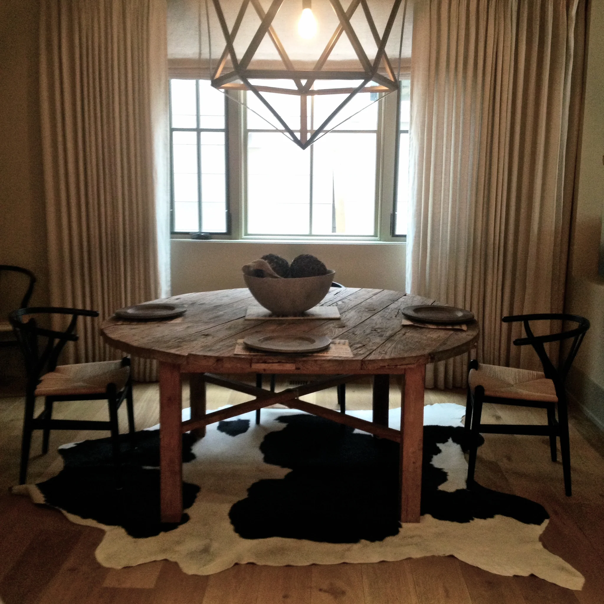 An "imperfect" space in one of our Altadore spec homes features fumed oak hardwood and an up-cycled barn door as a dining table. 