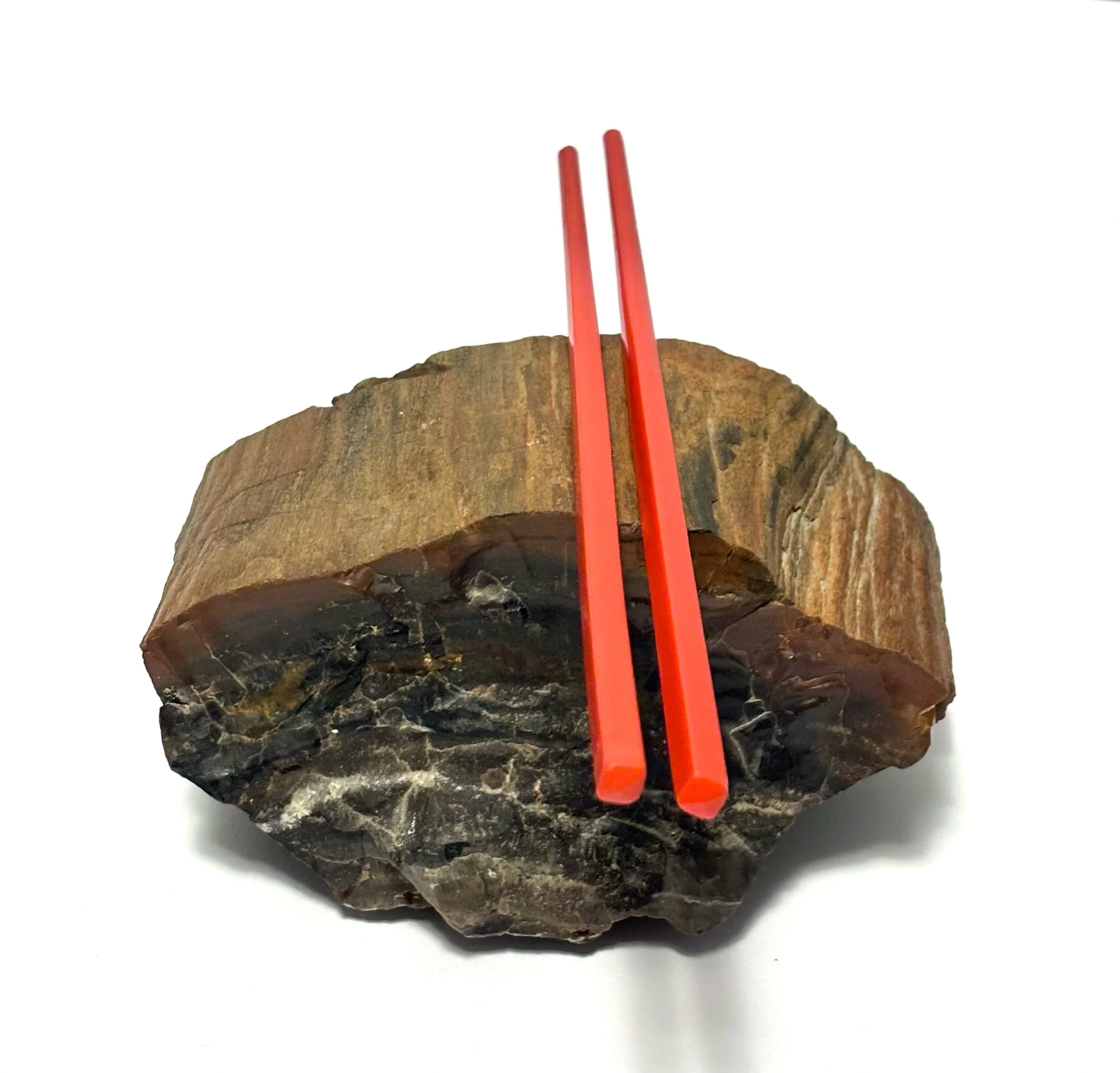 under (when i cared) petrified wood under acrylic chopsticks 