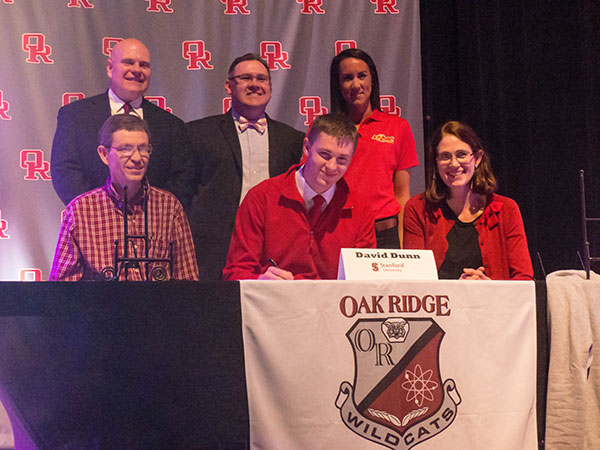 As family members and school and rowing officials look on, Oak Ridge senior David Dunn signs to row at Stanford University at Oak Ridge High School on Wednesday, Feb. 1, 2017. (Photo by John Huotari/Oak Ridge Today)