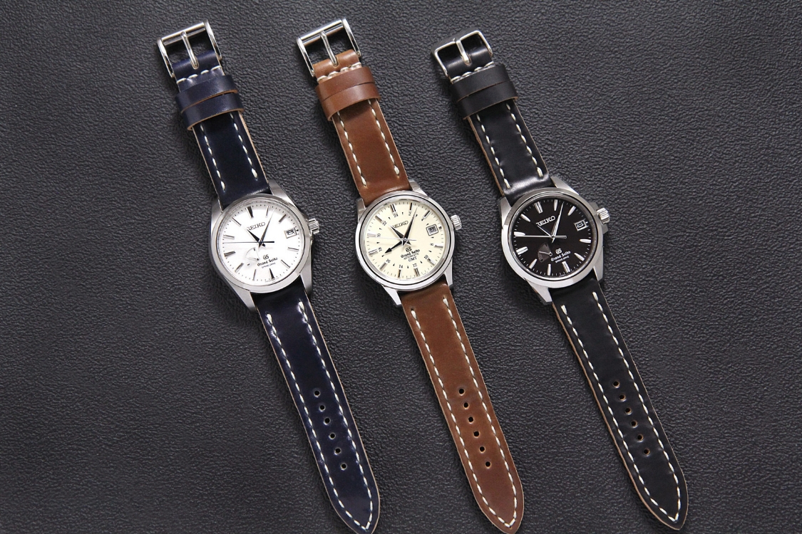 A spectacular trio of Grand Seikos on Arts & Crafts straps in Navy, Mahogany, and Black. Wow!