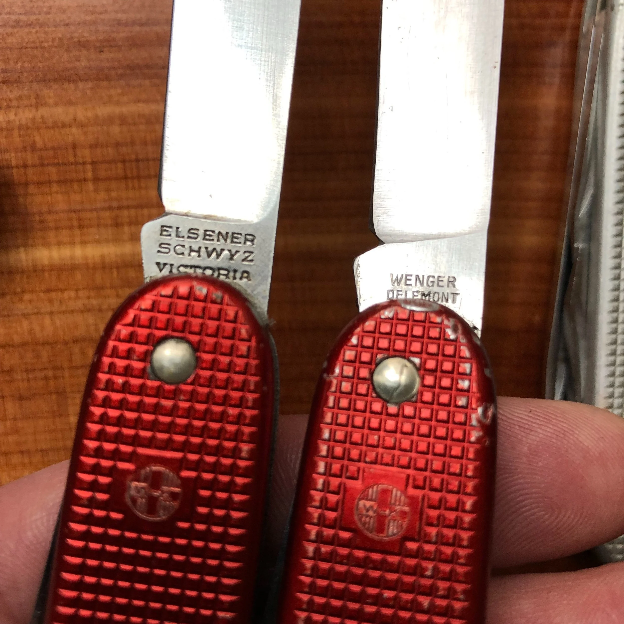 Tang stamps of Victorinox (L) and Wenger (R) version 1 SAKs.