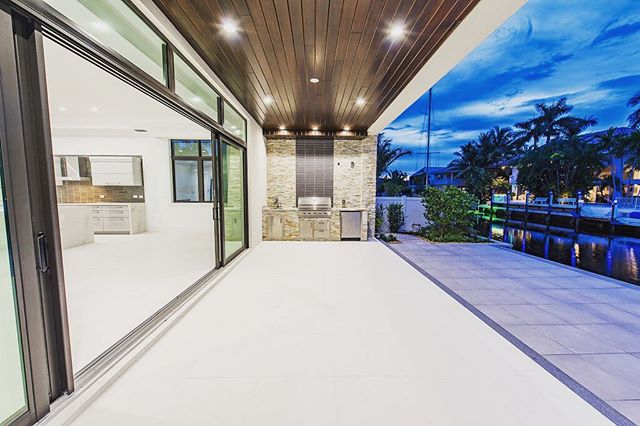 Outdoor covered patio with built-in BBQ. Gorgeous select grade Cyprus ceiling for that nice modern touch! #new #construction #custom #modern #contemporary #design #builder #realestate #soflo #boca #homeforsale