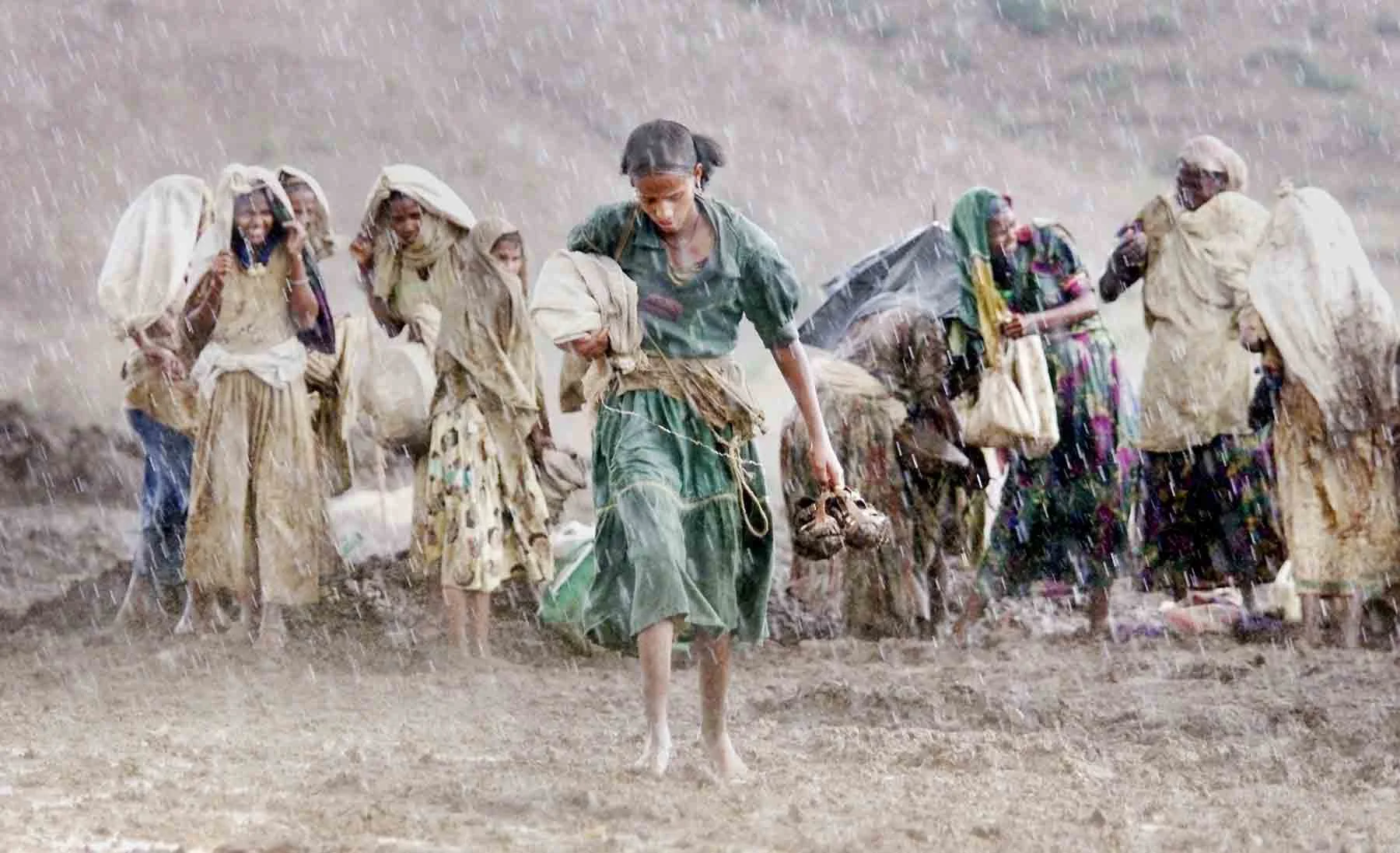 2000 A suprise burst of rain soaks workers at a dam building project. Central Tigray, Ethiopia.
