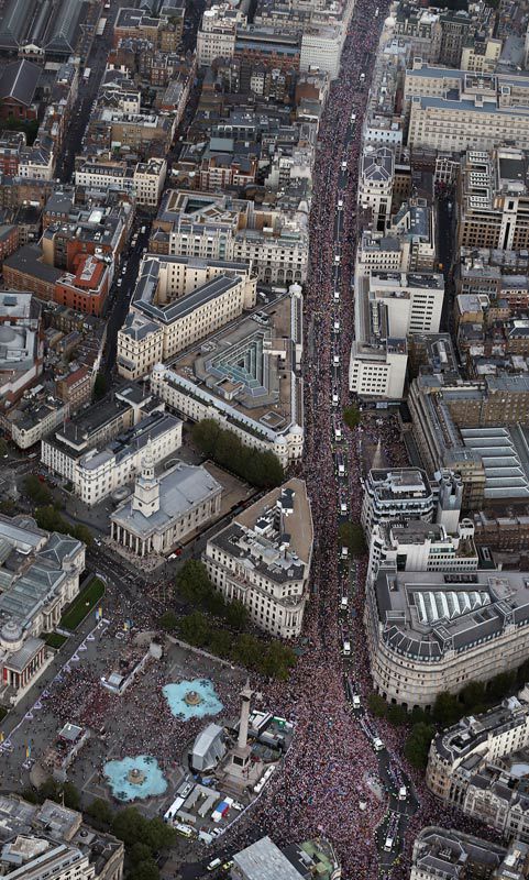 Trucks carrying British Olympians drive past Trafalgar Square. London, England. September 10, 2012.