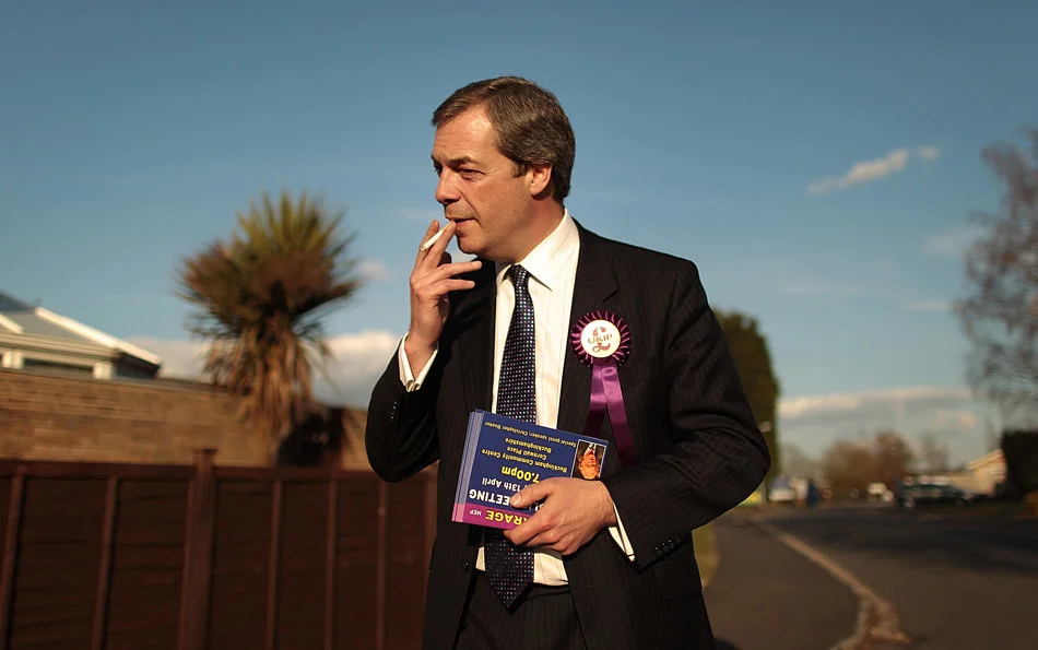 United Kingdom Independence Party (UKIP) leader Nigel Farage takes a cigarette break as he campaigns in the general election. Winslow, England. April 2010.