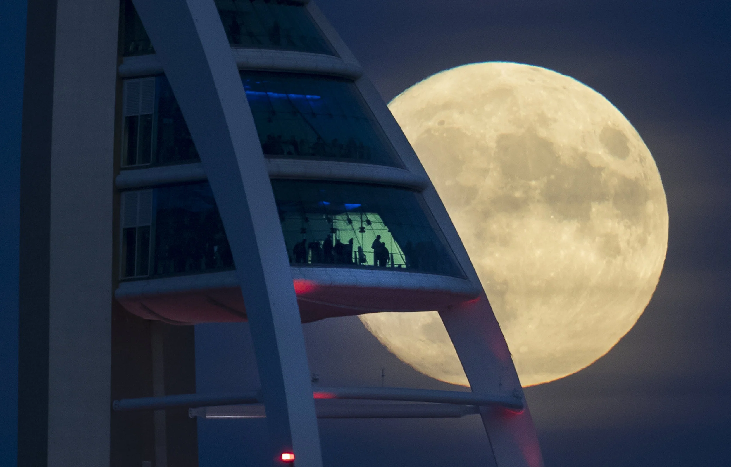 Moonrise seen by visitors to The Spinnaker Tower, Portsmouth, England. November 13, 2016.