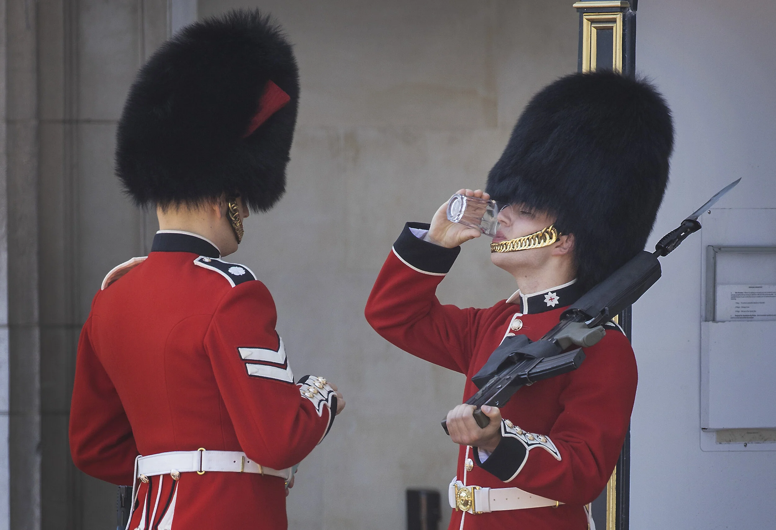 A member of The Coldstream Guards, on duty at Buckingham Palace, is given a drink of water during the extreme summer  heat on June 25, 2020.