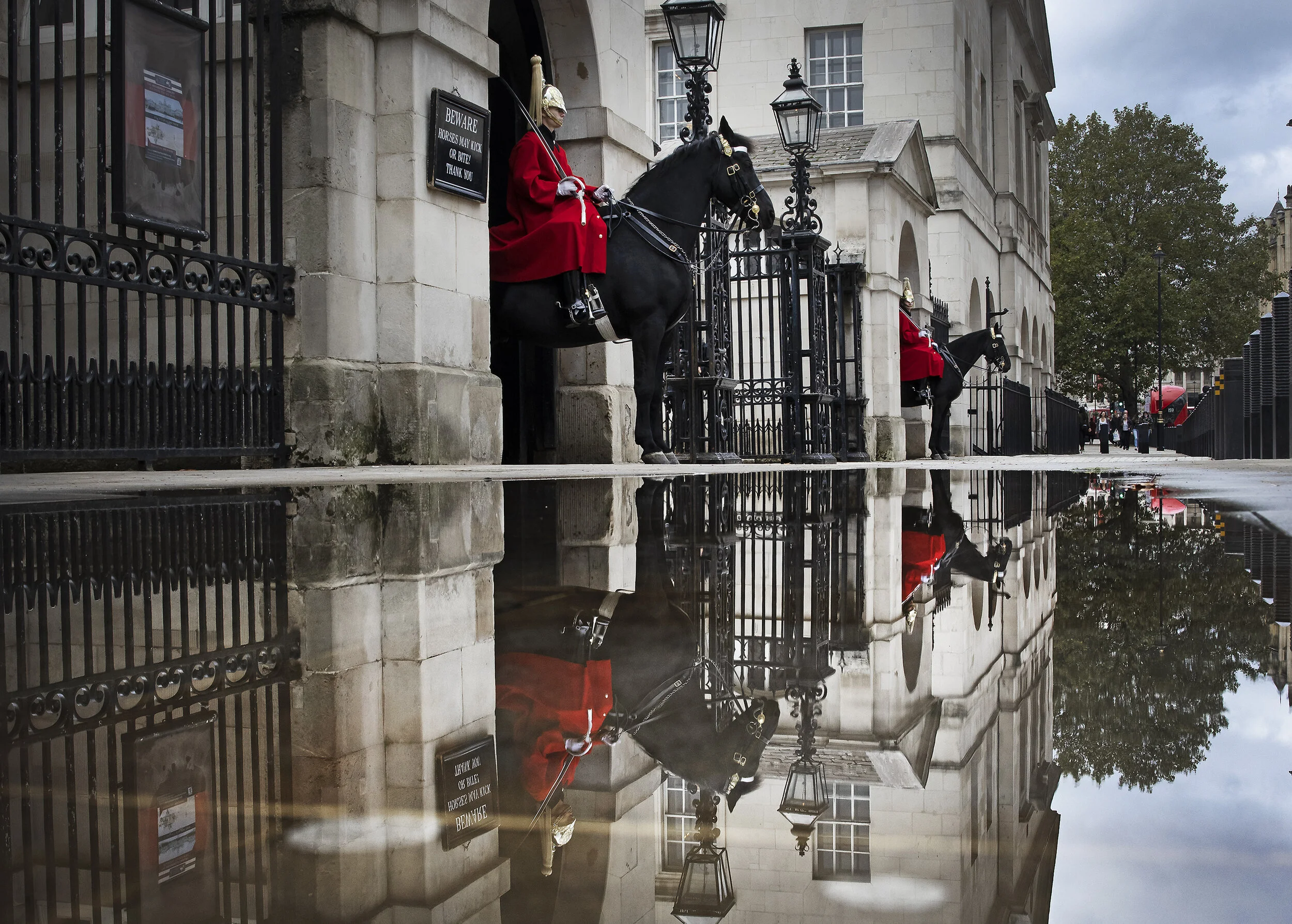Mounted troopers of the Household Cavalry on duty at Horse Guards are reflected in a puddle after heavy overnight rain as Storm Alex affects parts of the south on October 3, 2020.