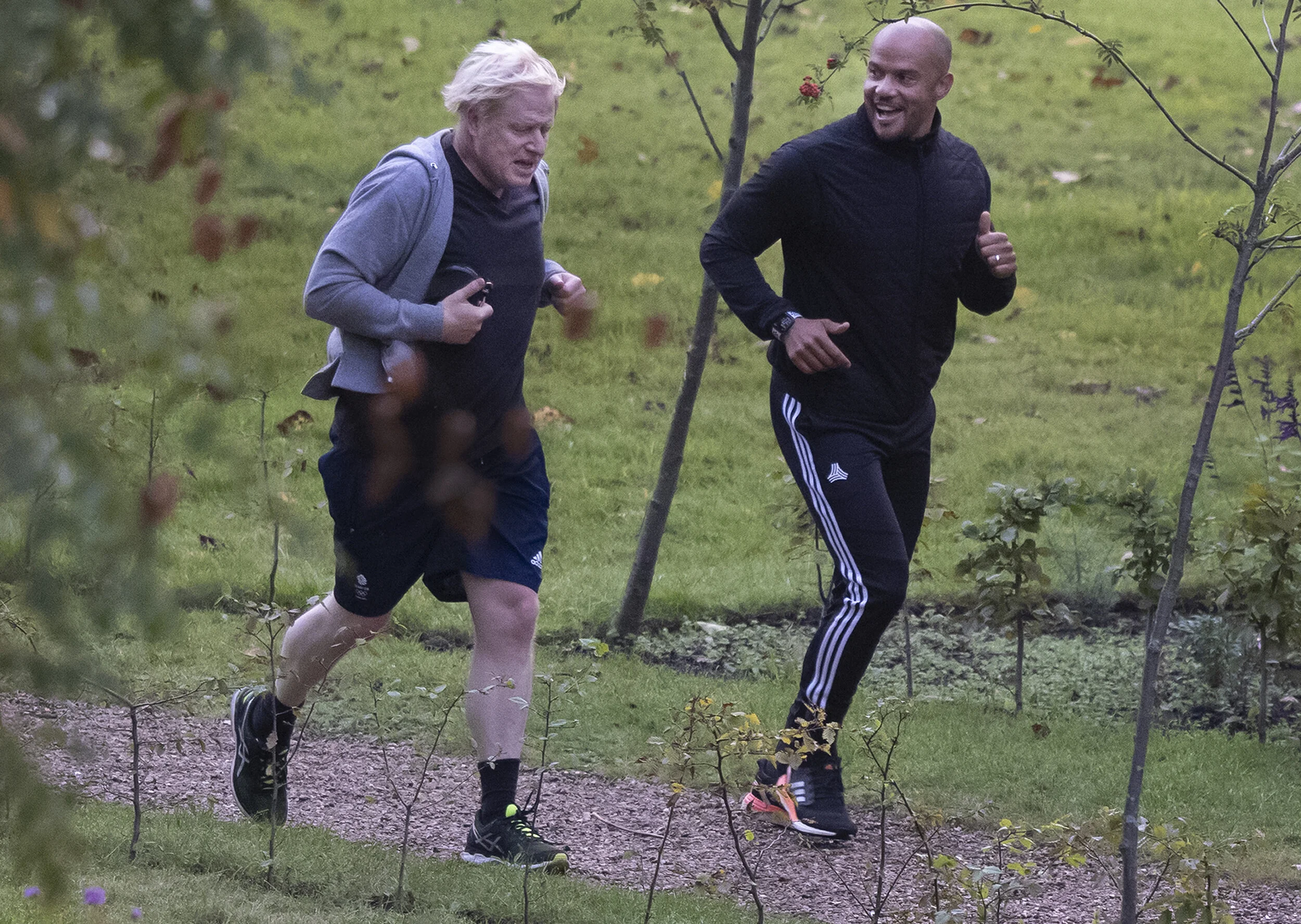 Prime Minister Boris Johnson goes for a morning run with his trainer Harry Jameson in Westminster on October 7, 2020.