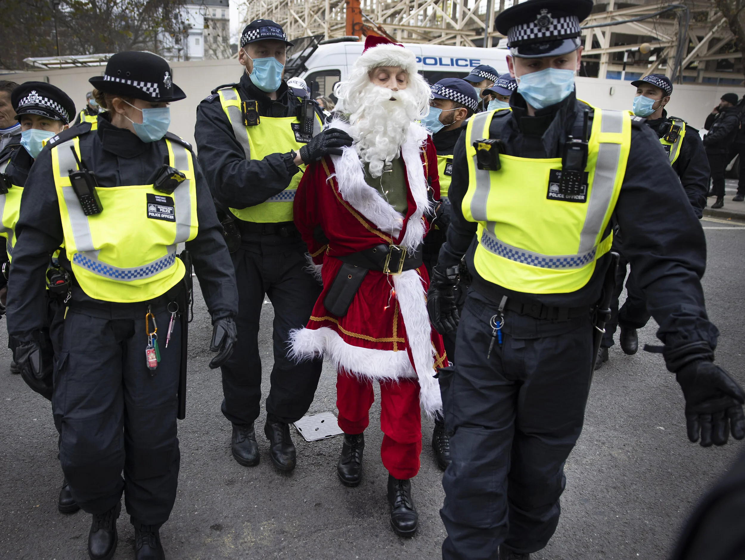 A protester dressed as Father Christmas is detained by police during an anti-lockdown march in central London on November 28, 2020.