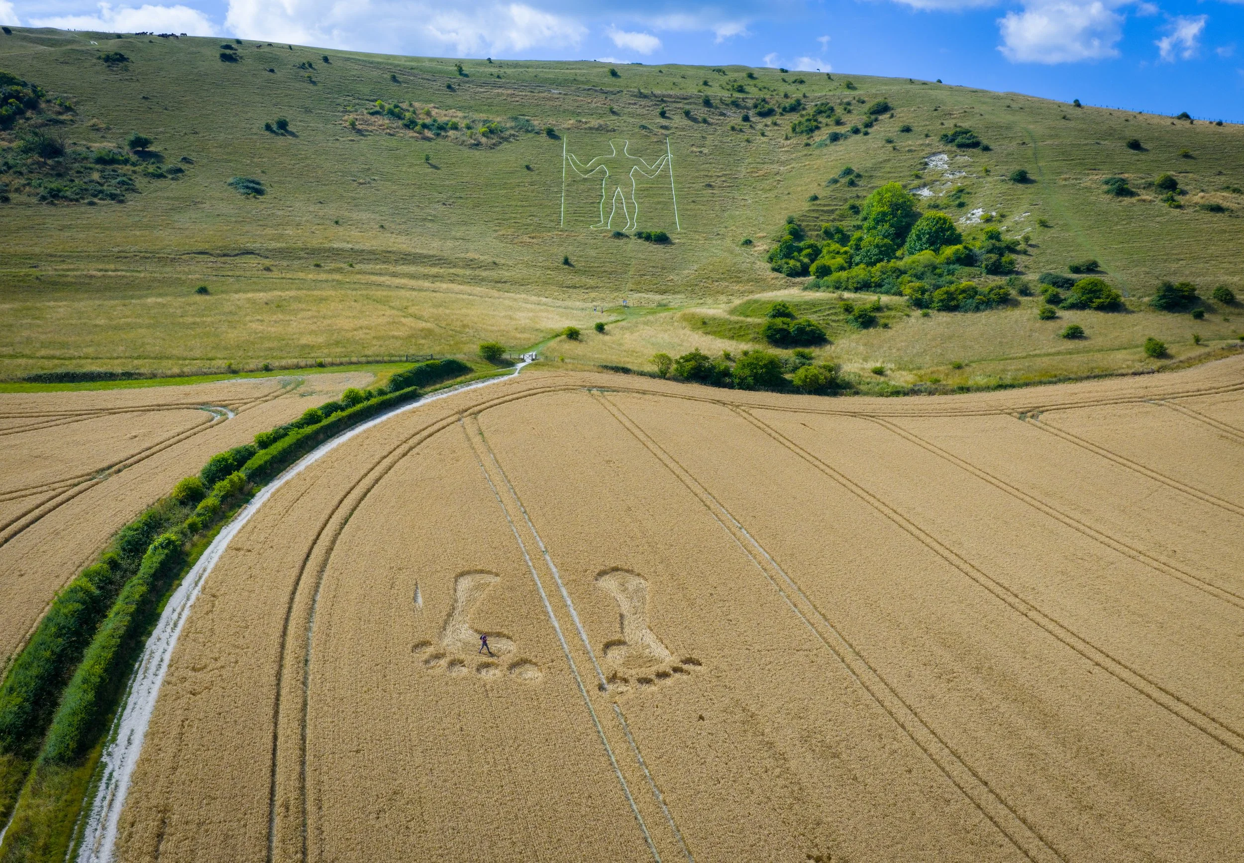 A giant set of footprints have been created in a cornfield in front of the world famous Longman of Wilmington in east Sussex on July 28, 2025.