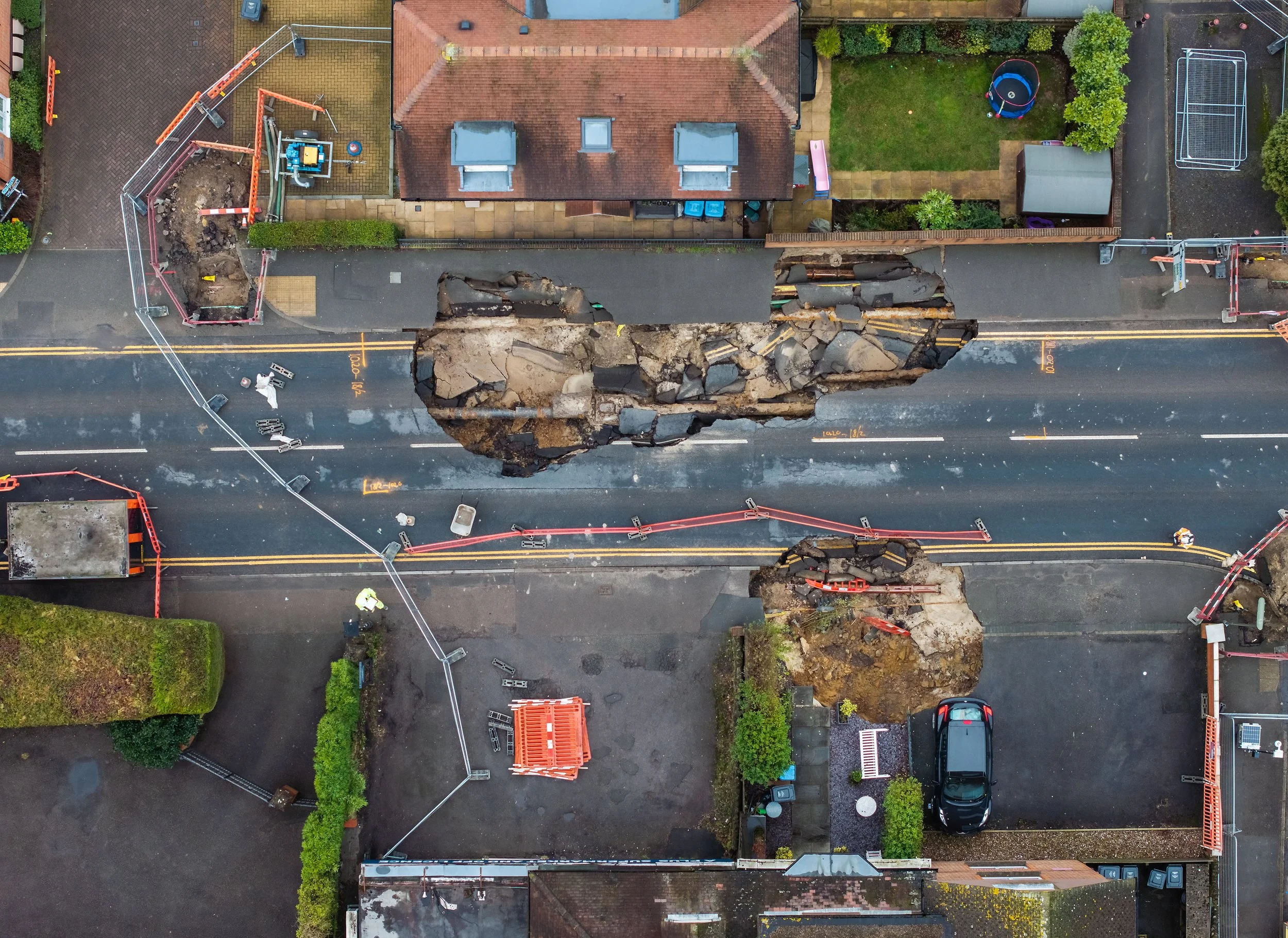A sinkhole has opened up on the High Street in Godstone, Surrey. Engineers are today scanning the ground to determine if there are any other cavities below the surface on February 22, 2025.