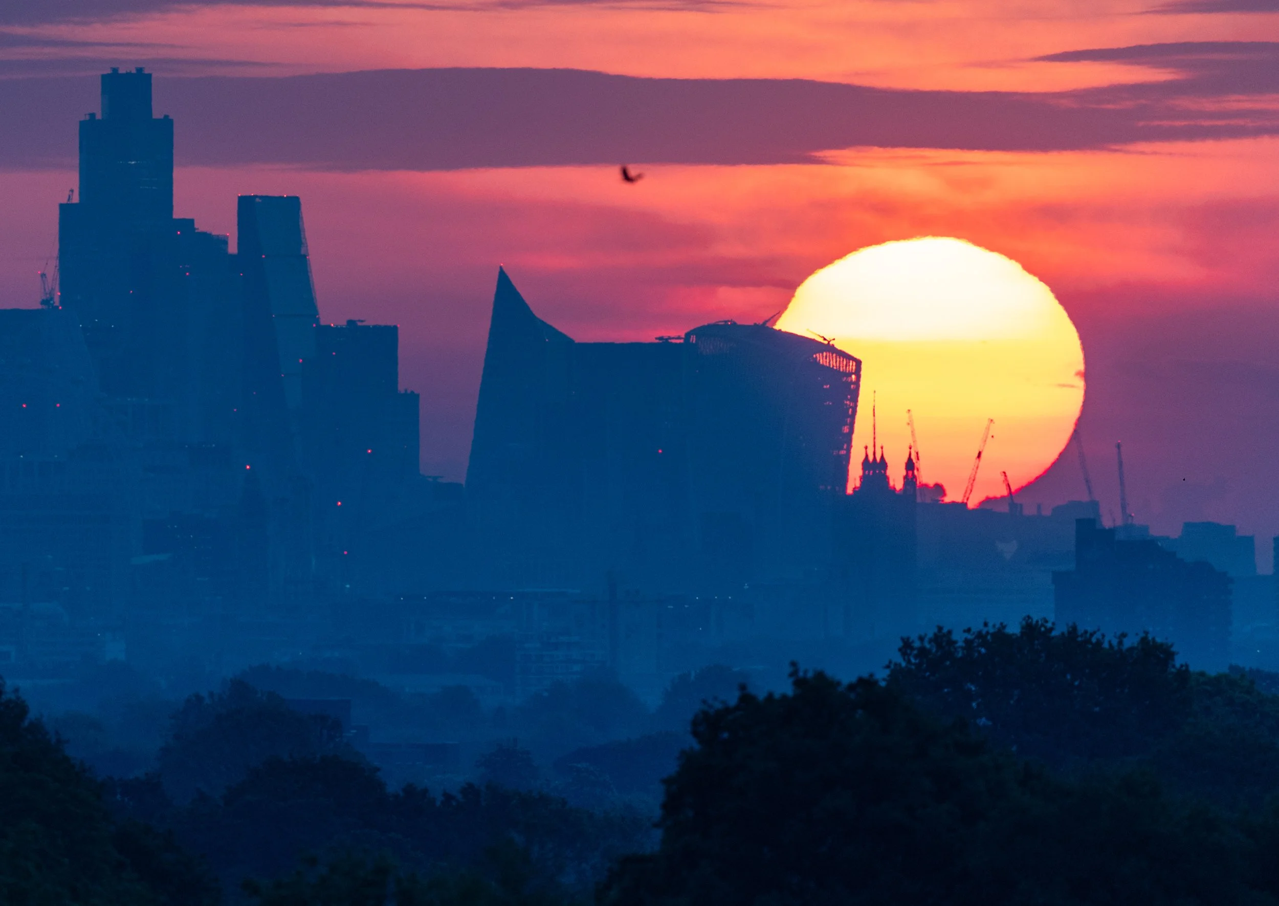 The sun rises into a cloudy sky over central London. Temperatures in the south of England are expected to hit 28 degrees today as the warm weather continues on May 2, 2025.
