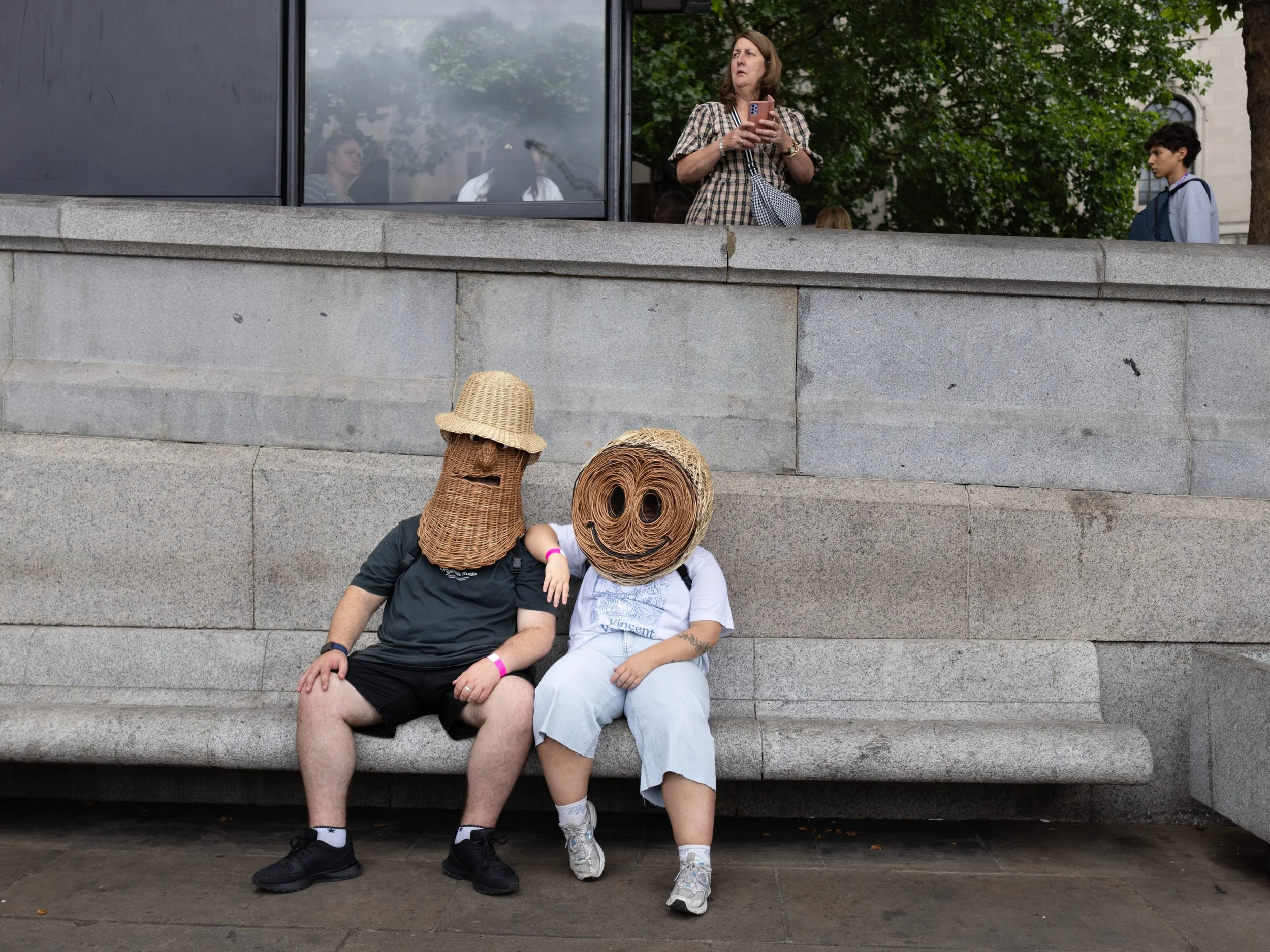 Members of The Playhouse artists wearing wicker heads sit in Trafalgar Square, central London during the Triumph of Art event and procession on July 26, 2025.