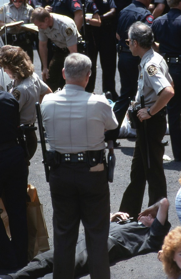 A Catholic priest going limp before his arrest.