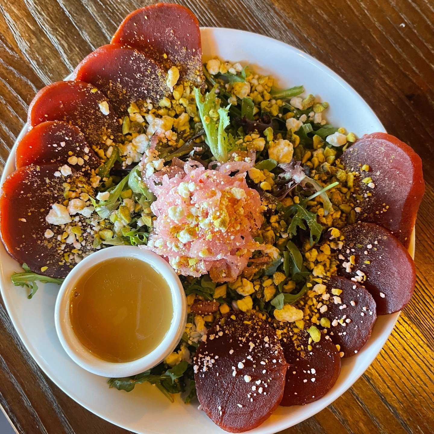 Our beet salad is perfect in the spring. With pickled red onion, beets, arugula, spring mix, goat cheese, and crushed pistachio, it's fresh and super tasty 🥗