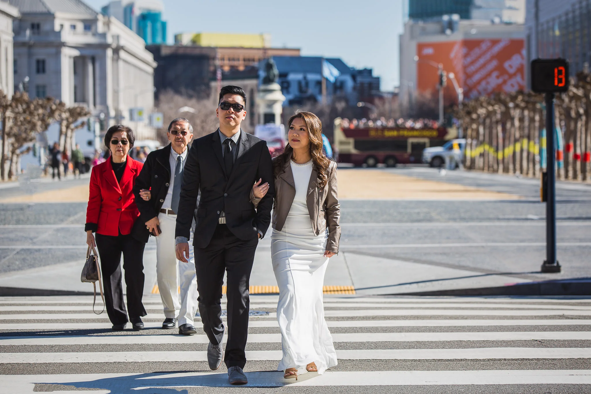 Kathy and Ken cross the street to SF City Hall as mom and dad follow. Notice the crosswalk countdown at 13, the day of their wedding!
