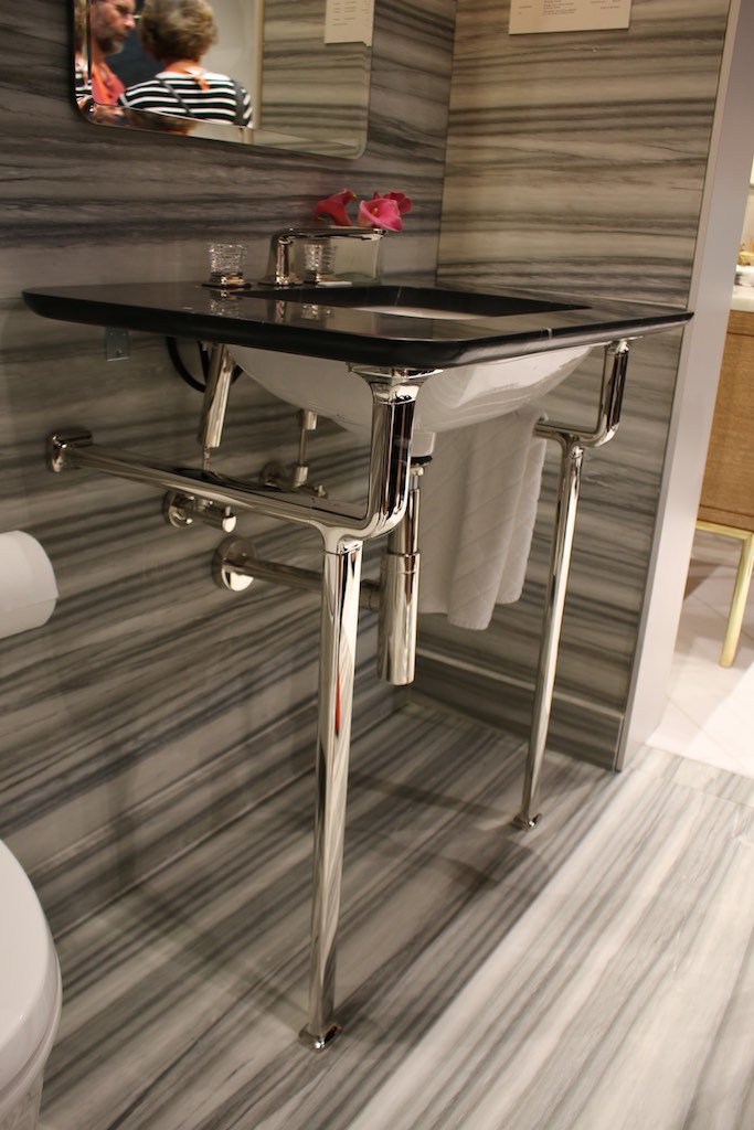 We loved how this Kallista Per Se Console Table Top was fabricated out of Nero Marquina and how is paired perfectly with the Ann Sacks Calacatta Zebrino that is seen on the walls and floor. Photo: Lisa Stewart Photography
