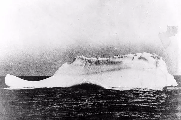 MINIA was one of the first ships to arrive at the scene of disaster, dispatched by White Star Lines to recover bodies and debris from the Titanic . Captain de Carteret stated that this was the only iceberg near the site of the collision. This photo earns more debate than the others, most likely due its resemblance or lack thereof (some argue that the iceberg has at this time flipped over, explaining the height of the line). There may have been other icebergs in that area, but how many? And with a red streak of paint (visible near midline) to boot?