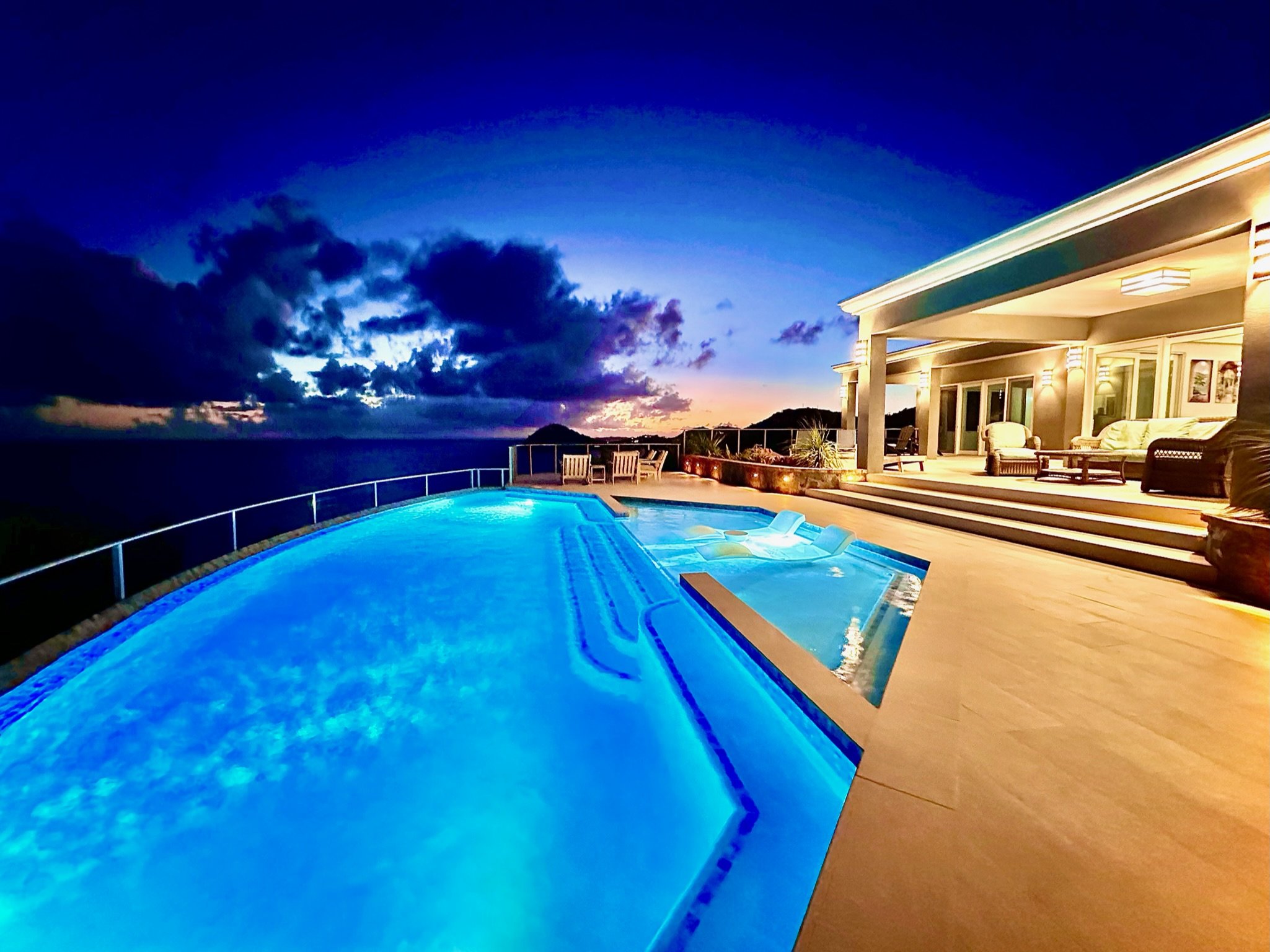 Driftwood Villa Outdoor Pool Lighting and Sunset in the Background.JPG