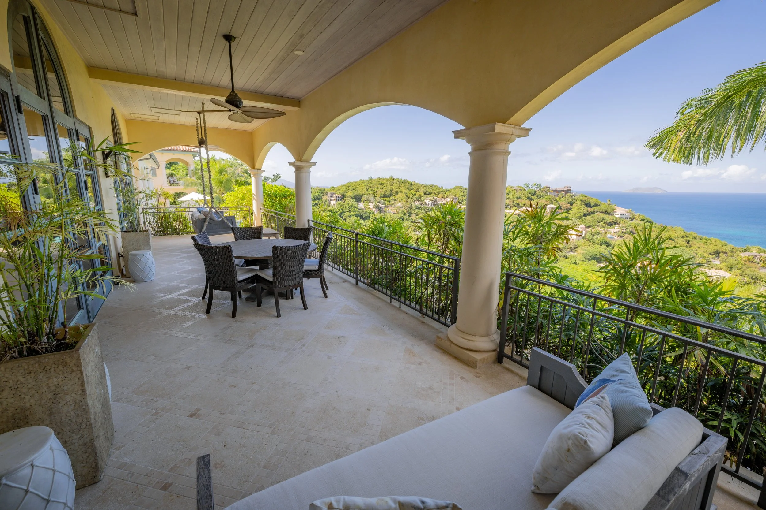 Outdoor patio with dining and a swing