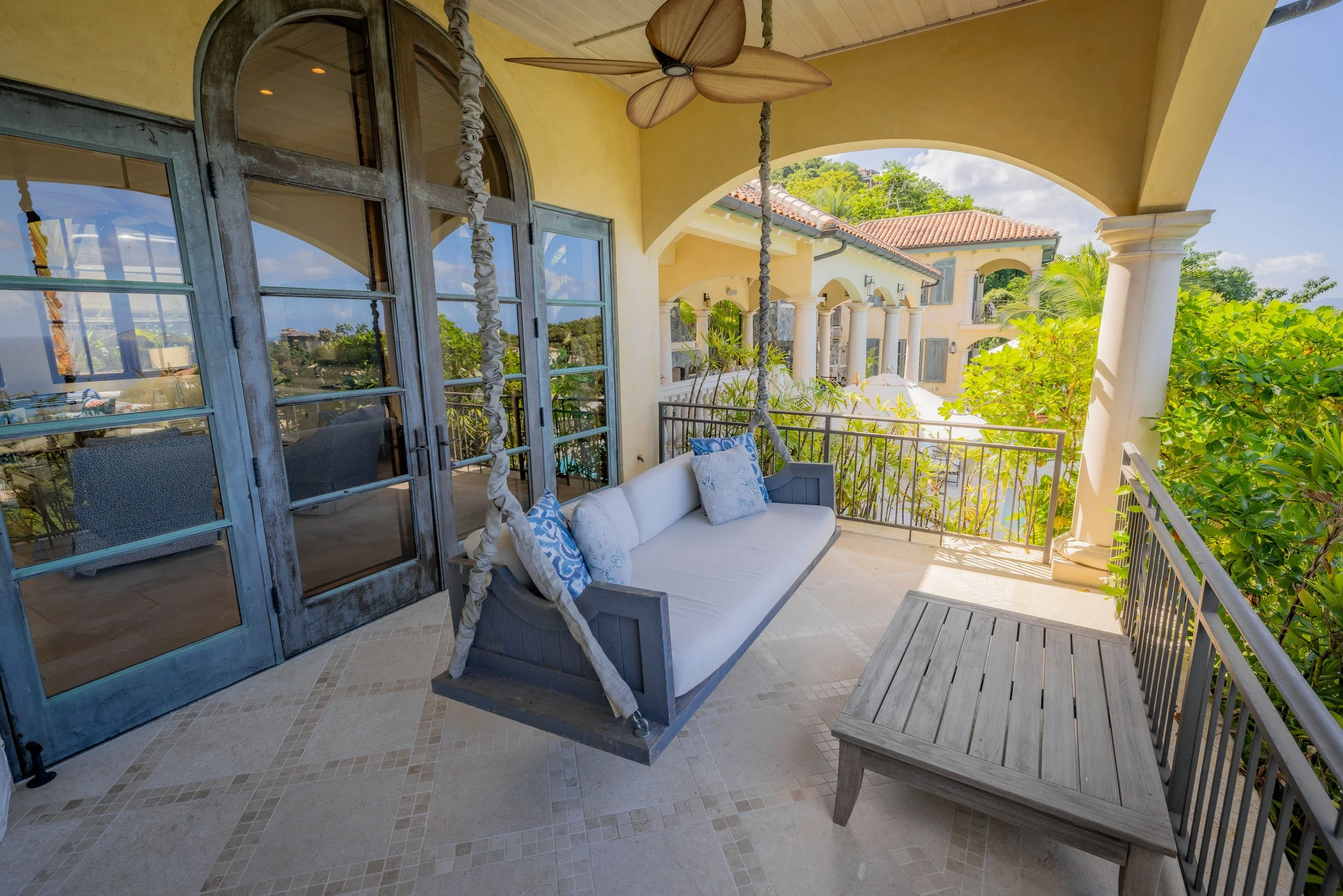 Outdoor patio with dining and a swing