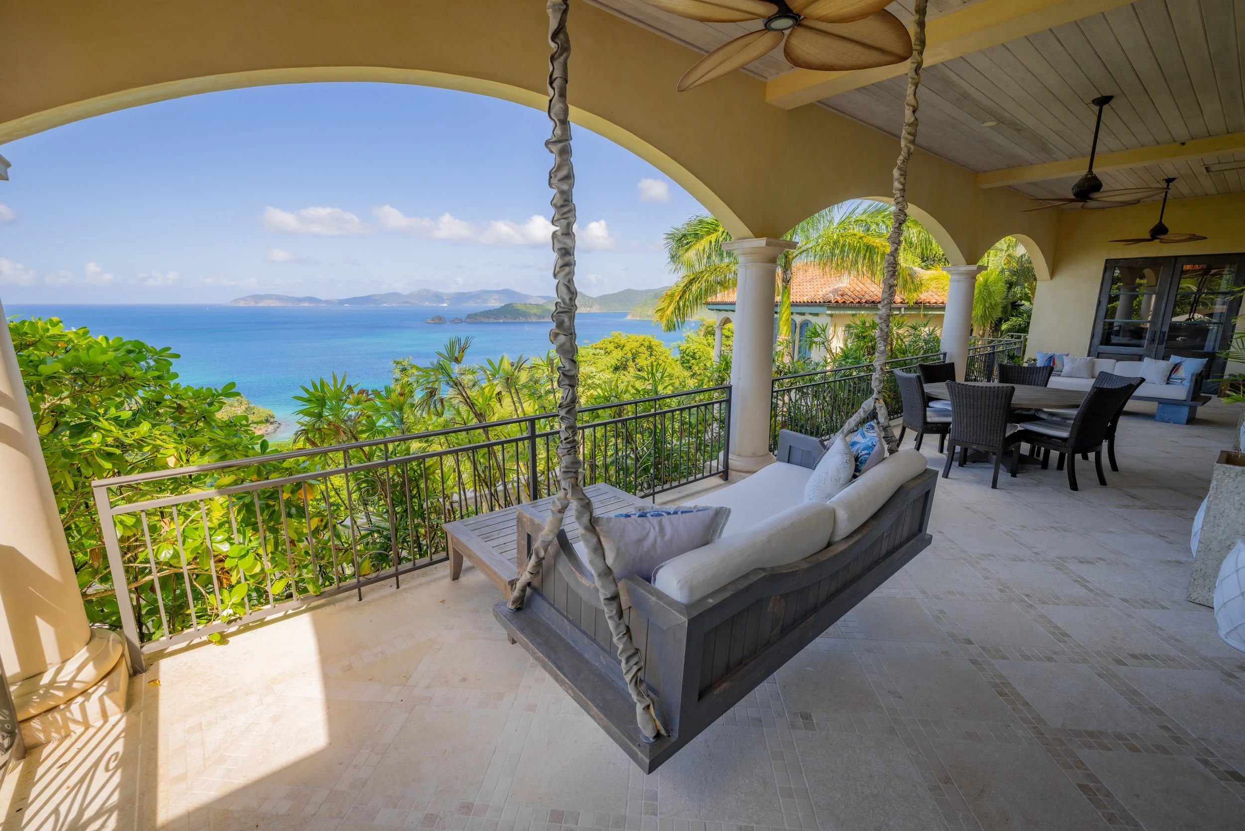 Outdoor patio with dining and a swing